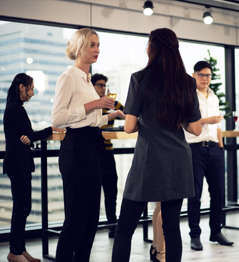 People in business casual ware drinking cocktails