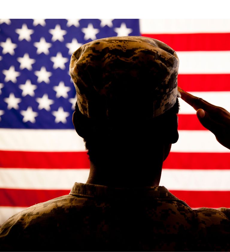 person saluting in front of American flag