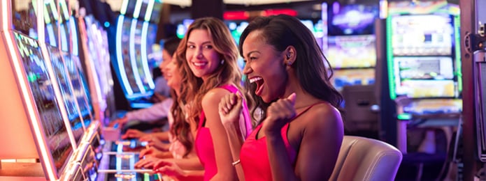 two women at slot machines