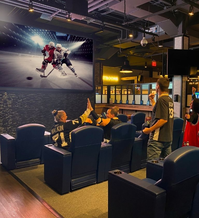 Fans Cheering on a Hockey Game on TV in the FanDuel Lounge