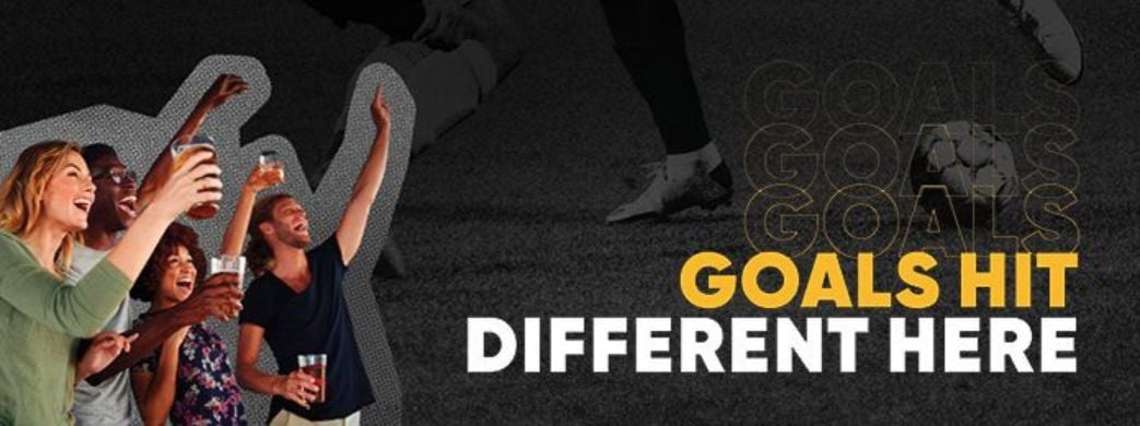 People waving their hands at a soccer game