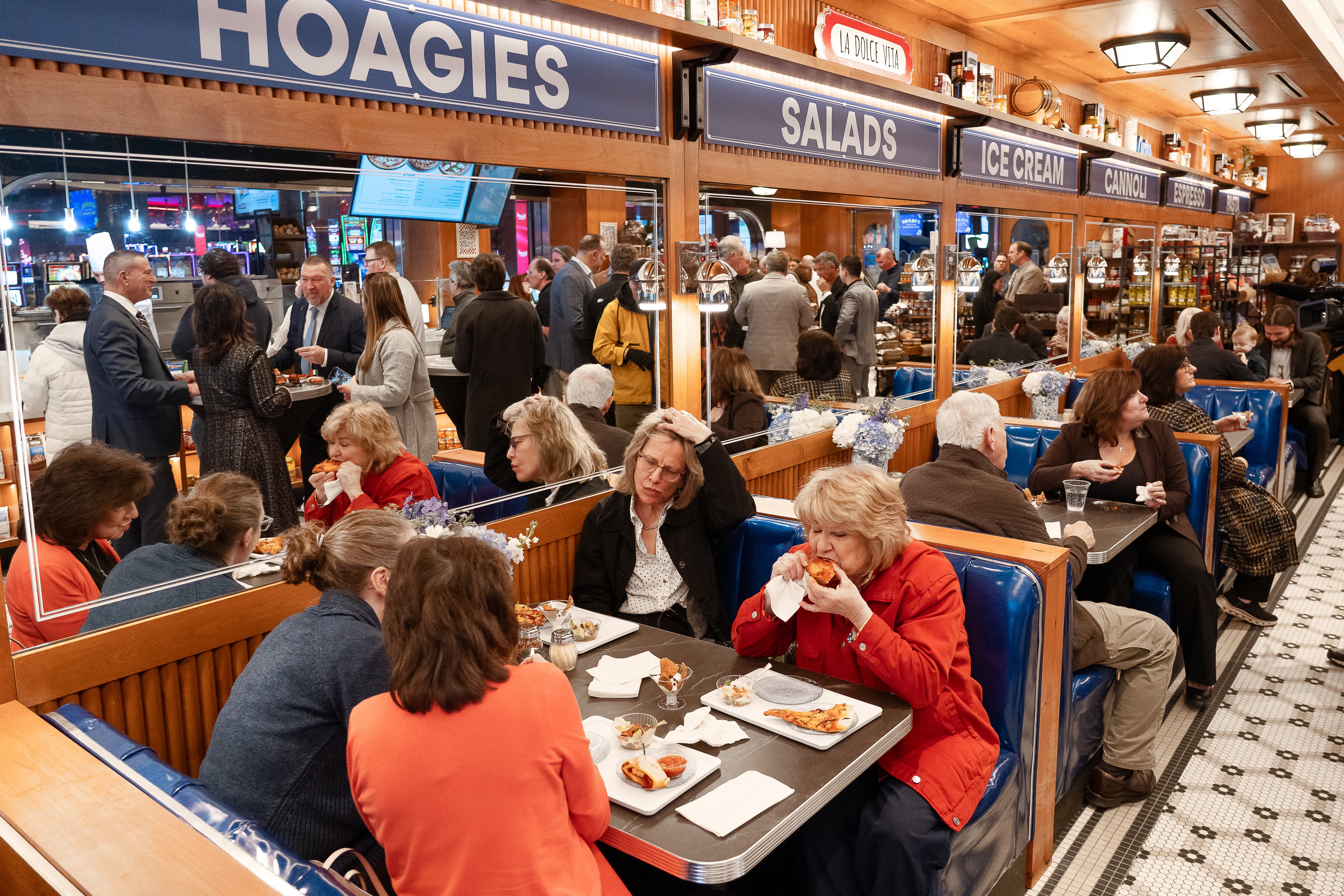 crowd of customers enjoying food at mangia