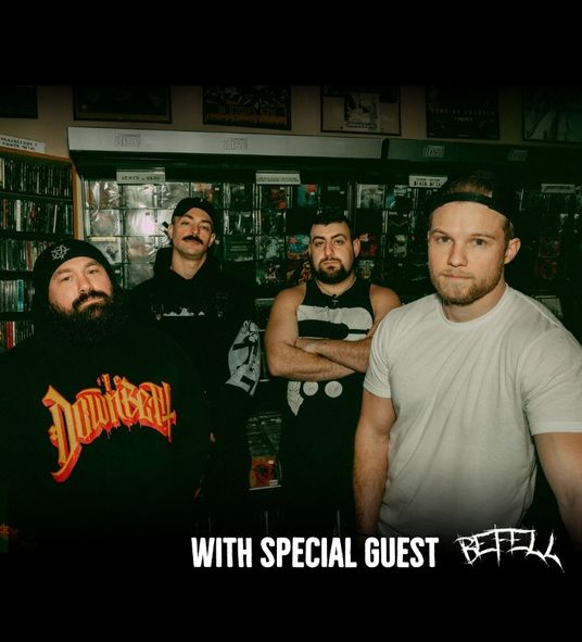 IRE Band group standing in a record studio