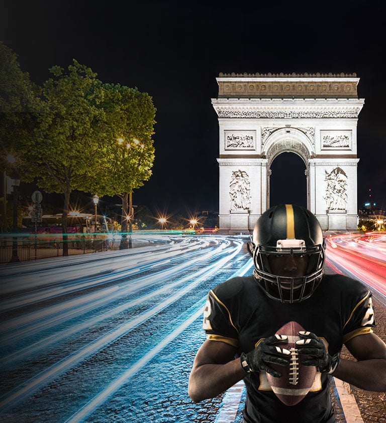 black background with a steelers player in paris holding a football