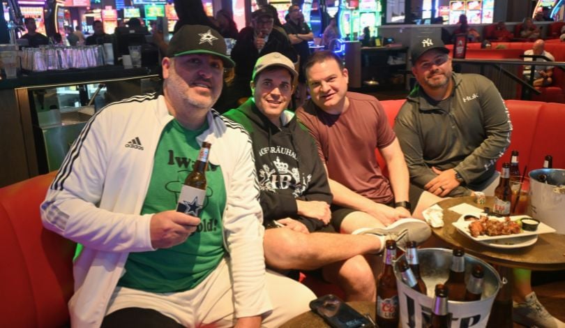 image of four men hanging out and drinking beer at sports & social louisiana