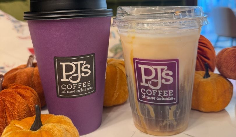 image of two coffee drinks with pumpkin decor on a counter