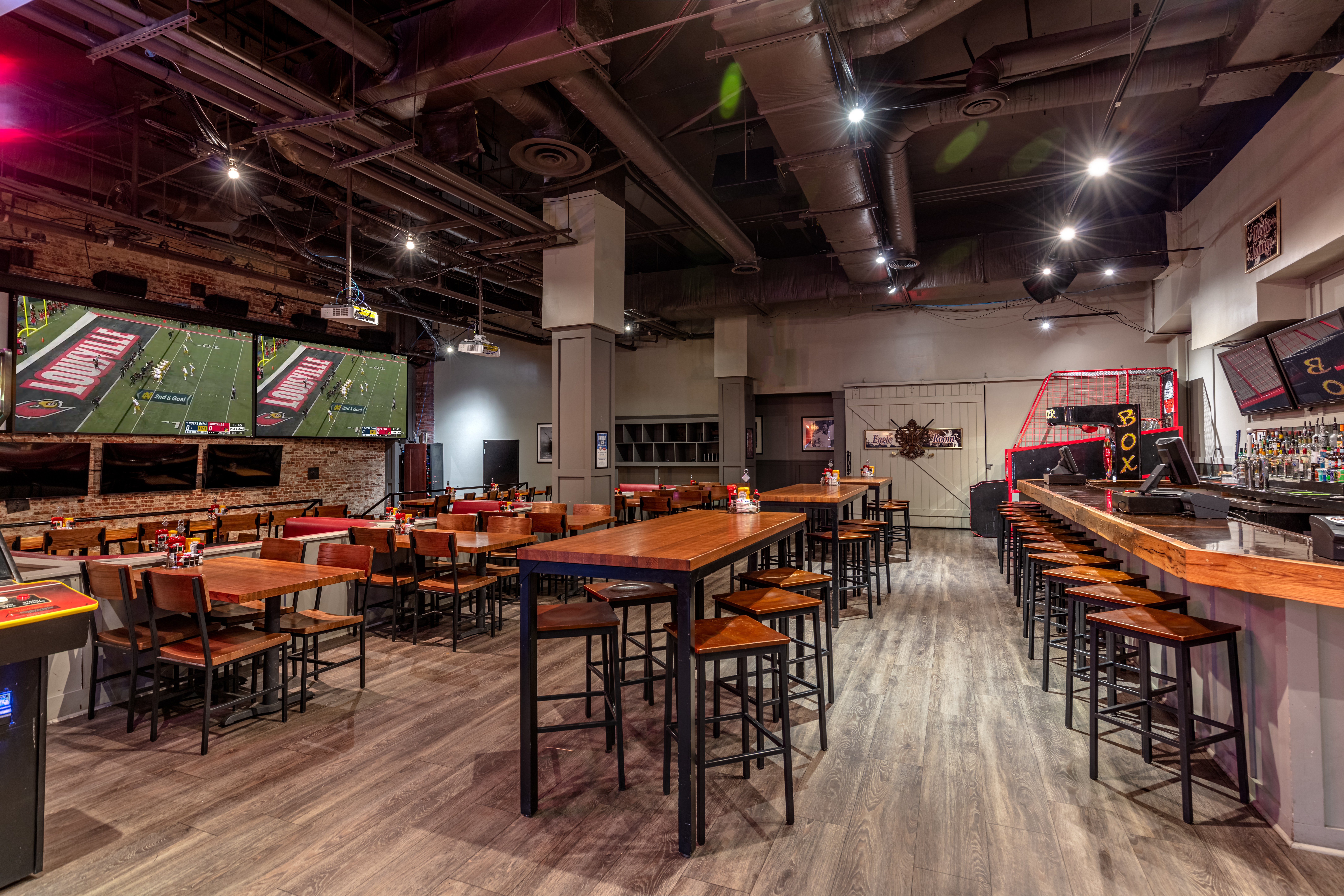 Sports & Social Media Room displaying several TVs and tables