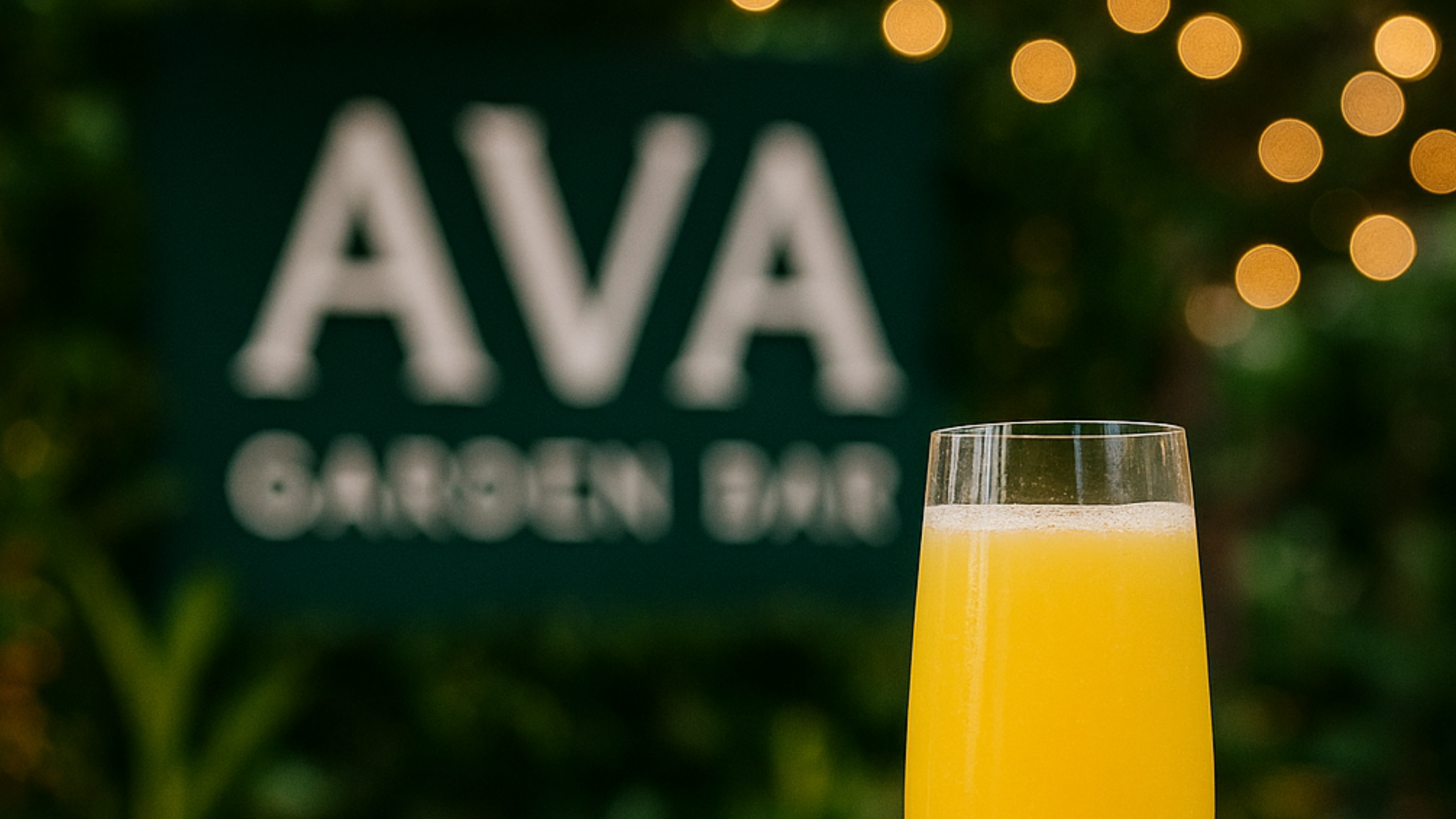 Mimosa in front of AVA Garden Bar sign