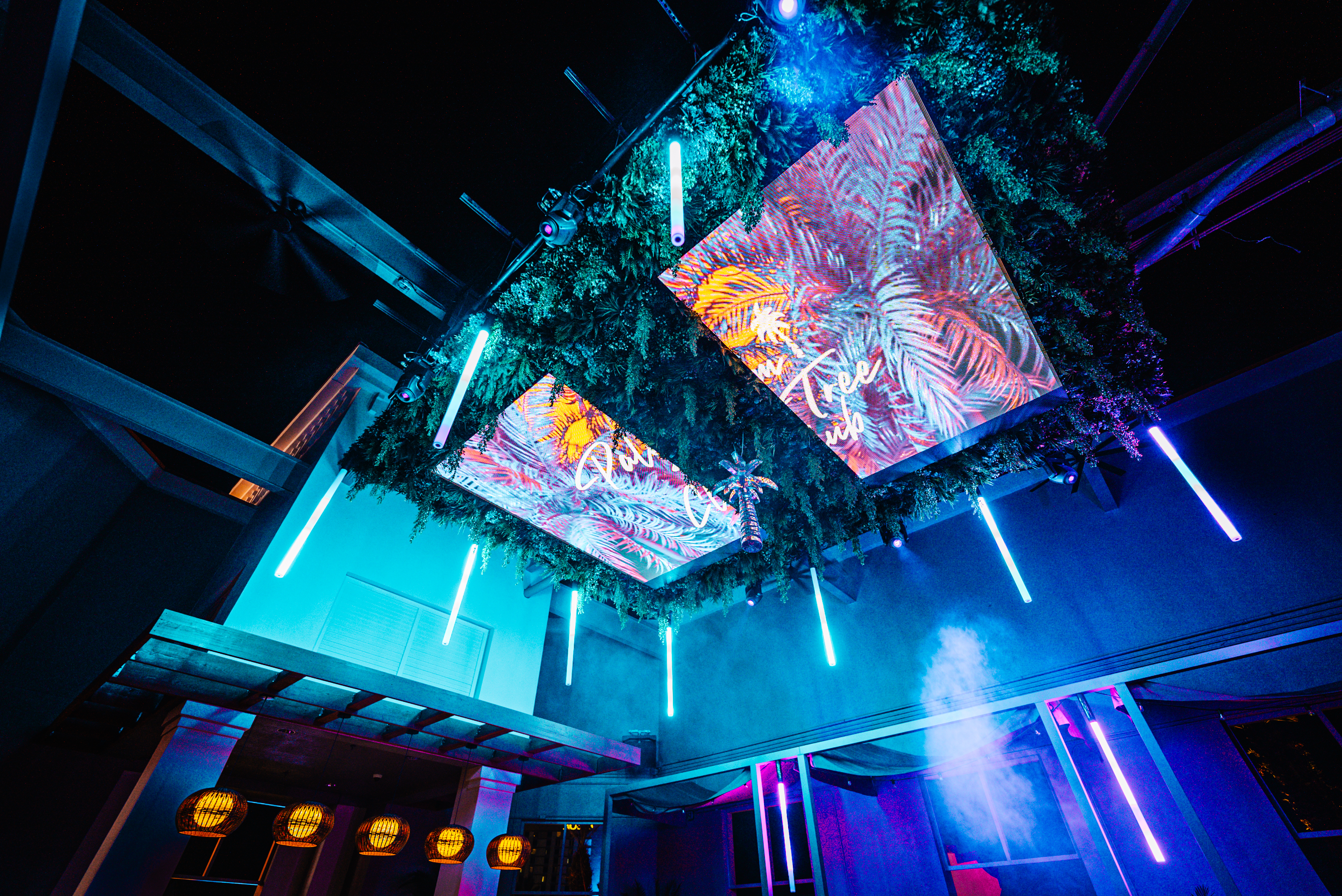Palm Tree Club Rooftop Orlando ceiling with glowing palm tree LED panels and neon lights.