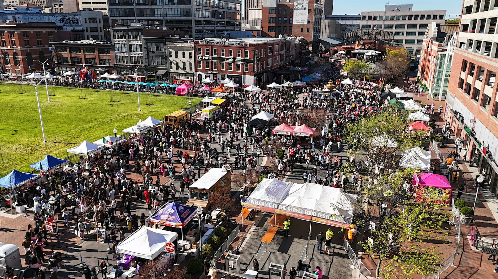 Aerial view of a busy outdoor street food festival at Power Plant Live! with tents and large crowds.