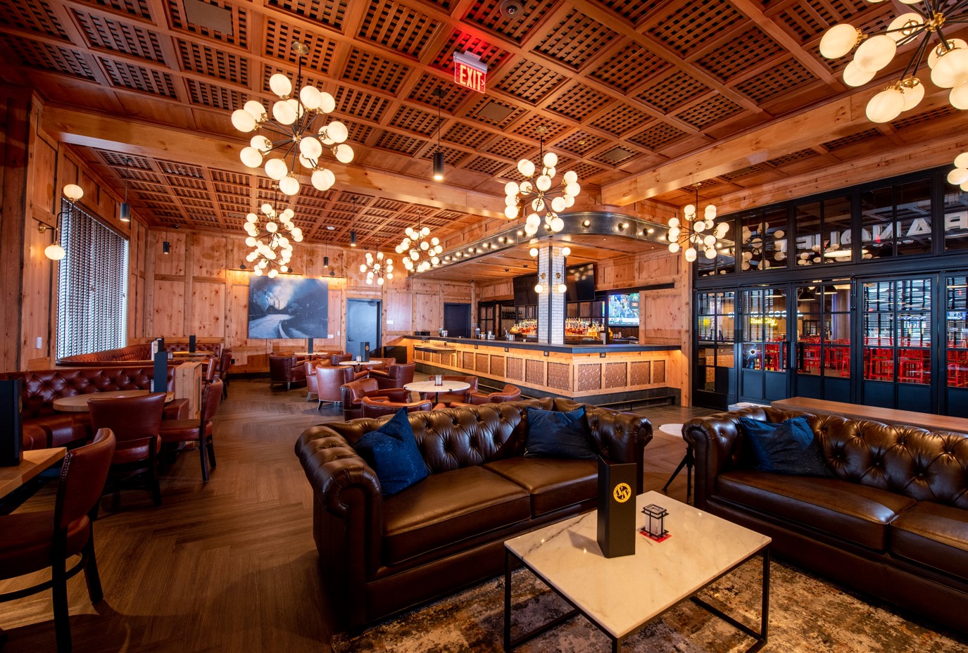 The social club with couches, tables, and chairs