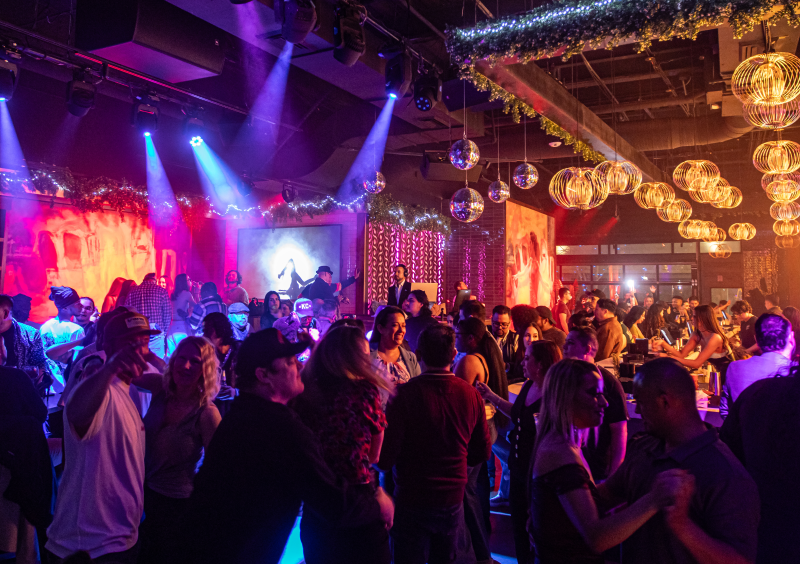 Vibrant nightlife at Besos y Abrazos bar and restaurant.