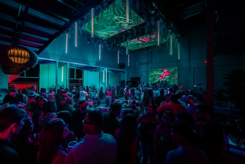 Crowded dance floor at Palm Tree Club lounge at Live! at the Pointe Orlando.