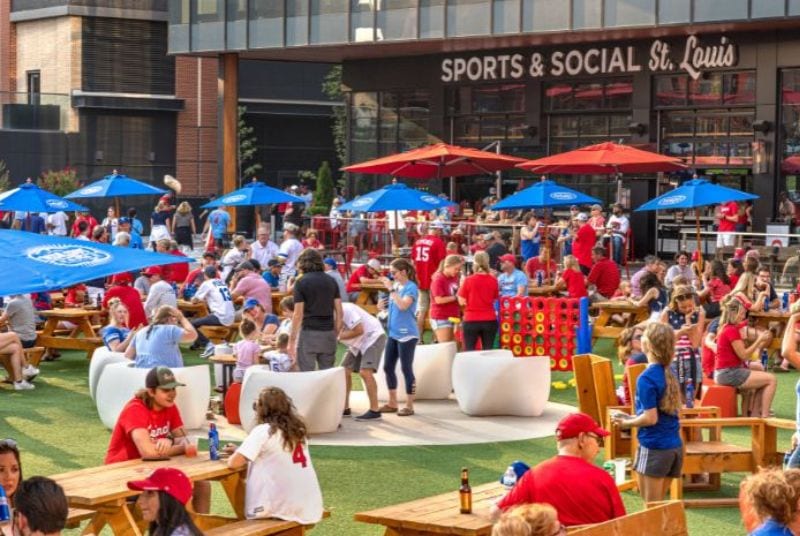 Cardinals fans and their children fill picnic tables and play games while enjoying the great menu at Sports & Social.