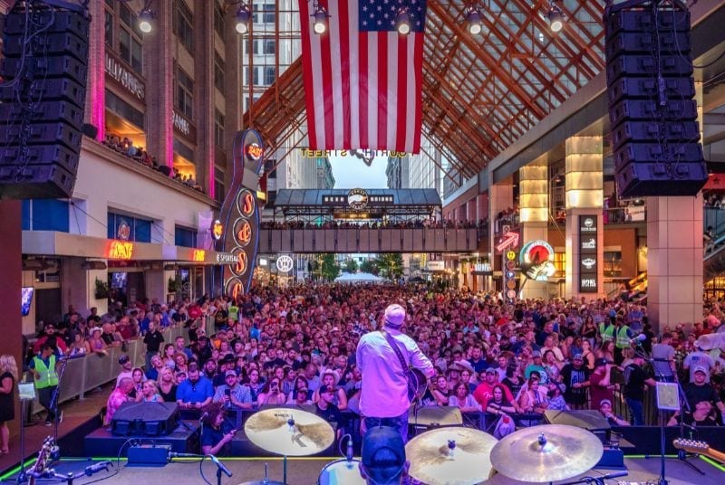 The view from behind the drums as a singer plays his guitar to a packed concert crowd at Fourth Street Live!