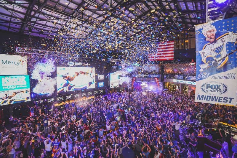 Celebrating the Blues winning the Stanley Cup with a huge cheering crowd and confetti falling from the rafters!