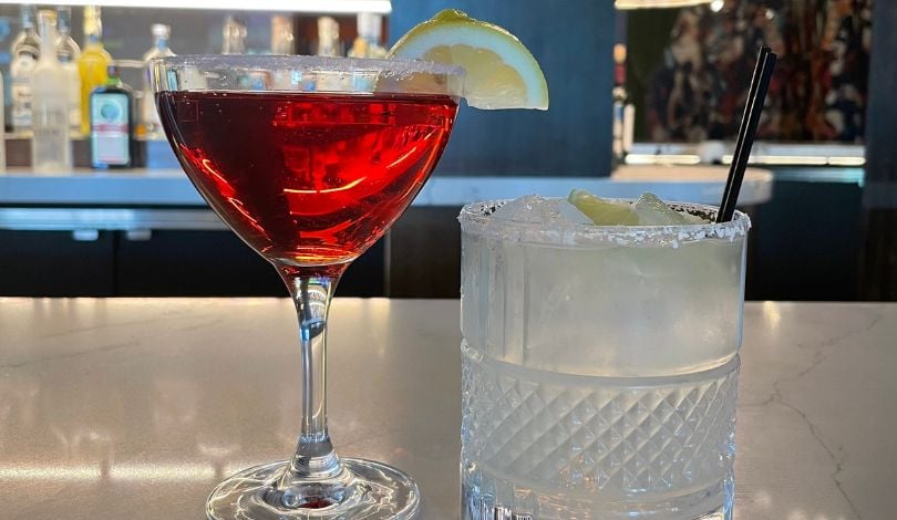 image of a red martini in a martini glass and a lime margarita in a short cocktail glass