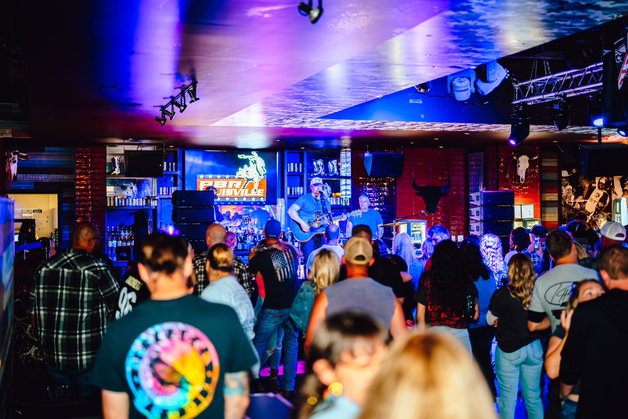 crowd listening to live entertainment at pbr cowboy bar