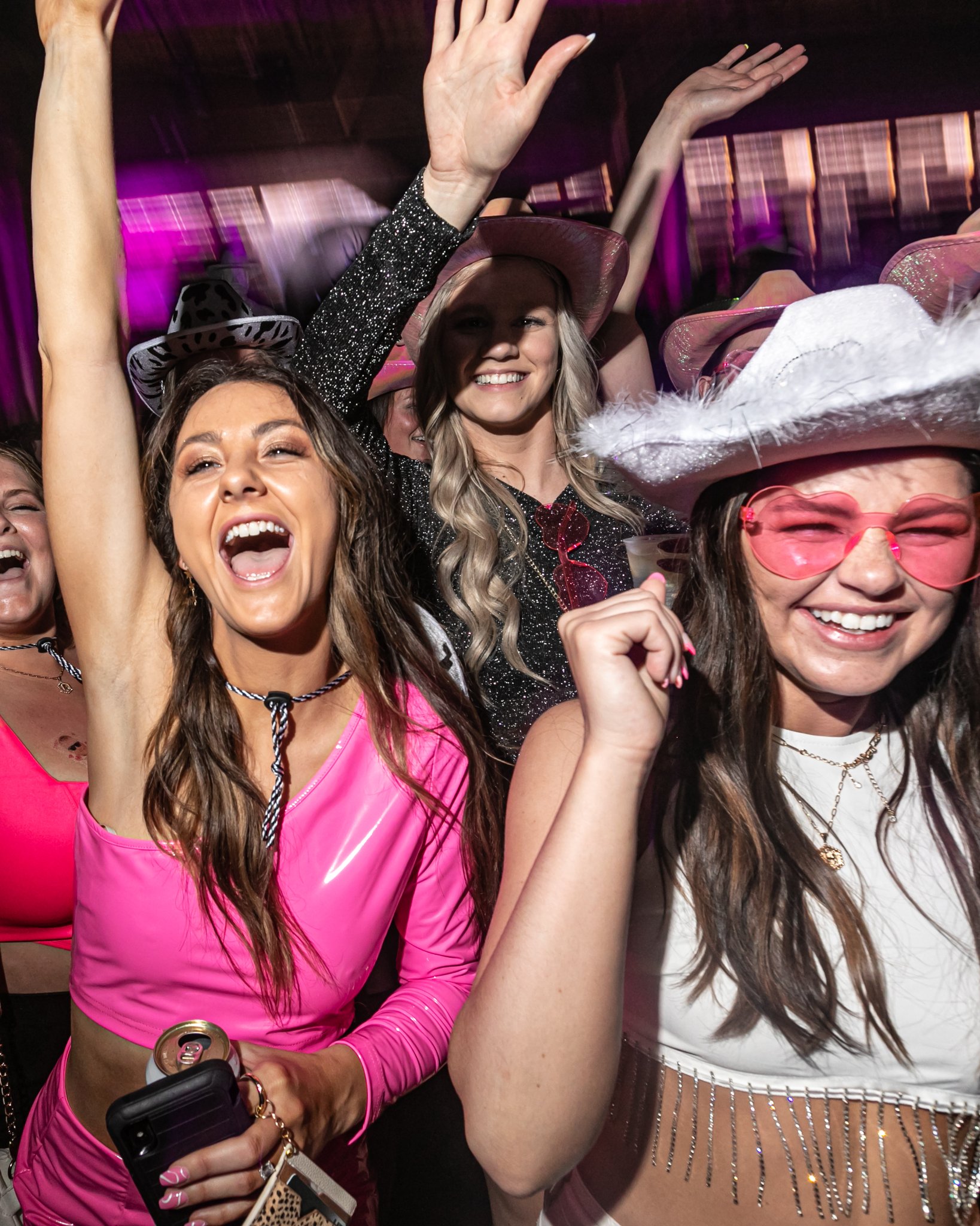 Girls celebrating at PBR in cowgirl hats