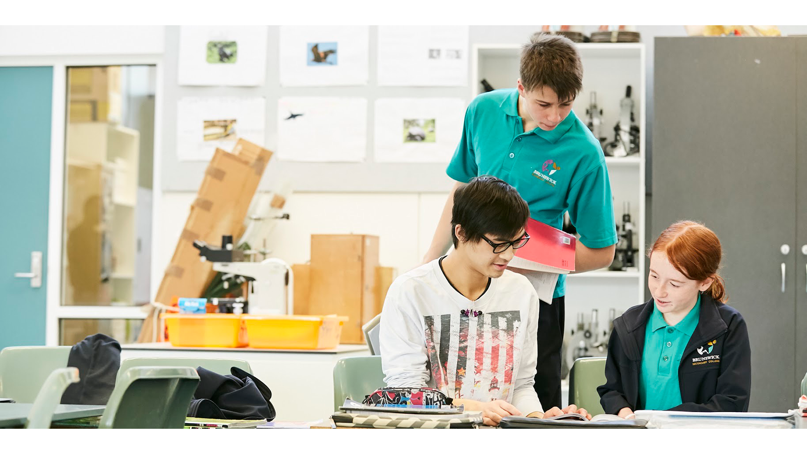 Three school children In a Science Classroom