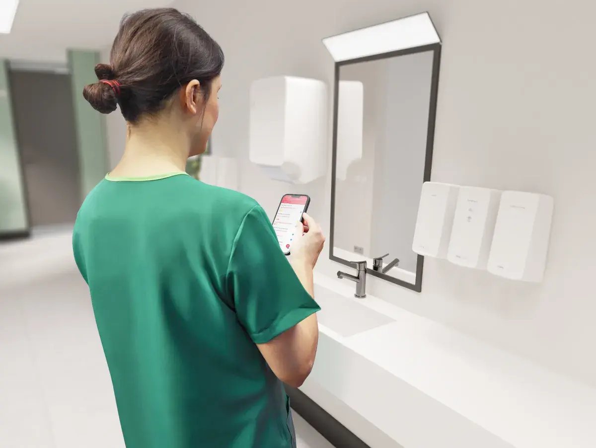 standing_in_washroom_swiping_on_phone_-_over_the_shoulder_0.jpg