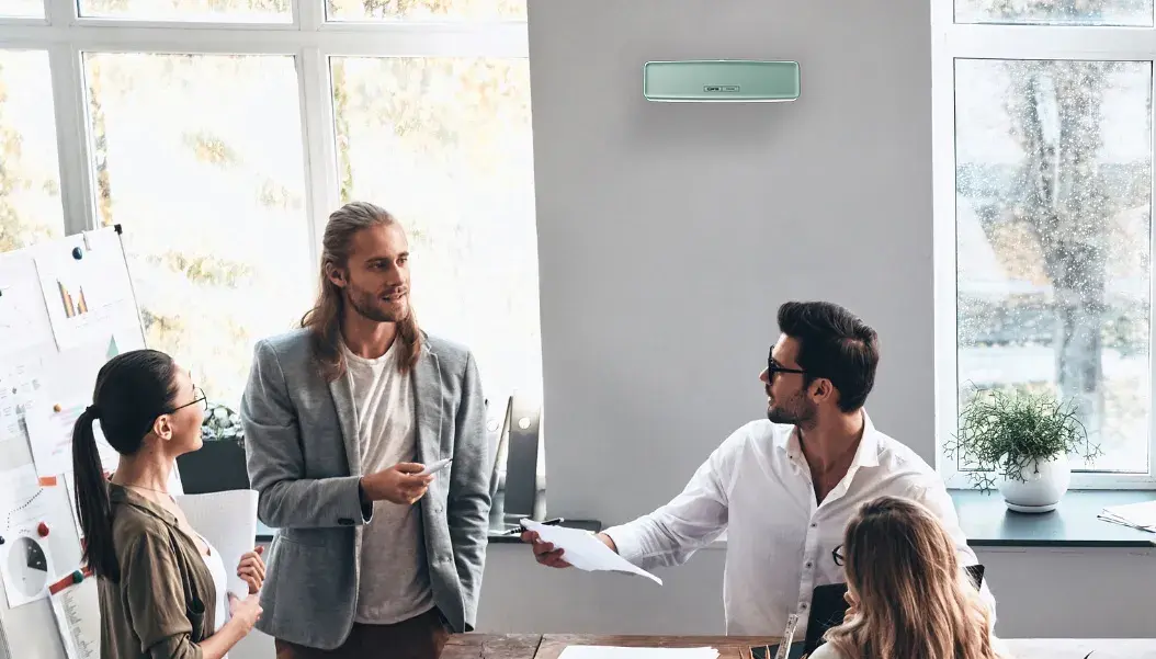 CWS PureLine AirBar namontovaný na stěně v konferenční místnosti plné lidí
