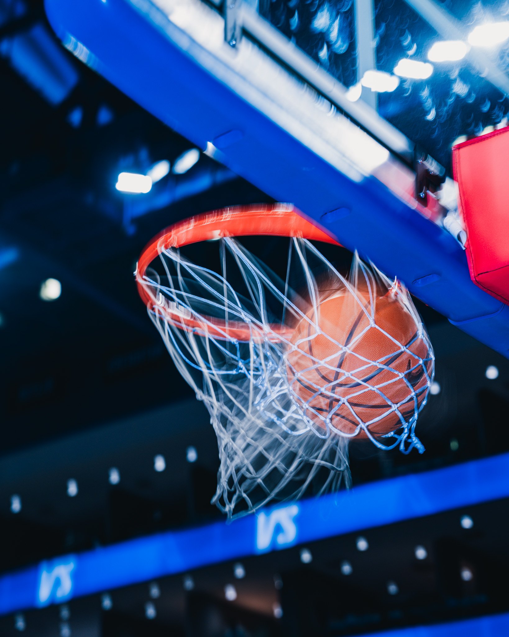 Basketball growing through a hoop.