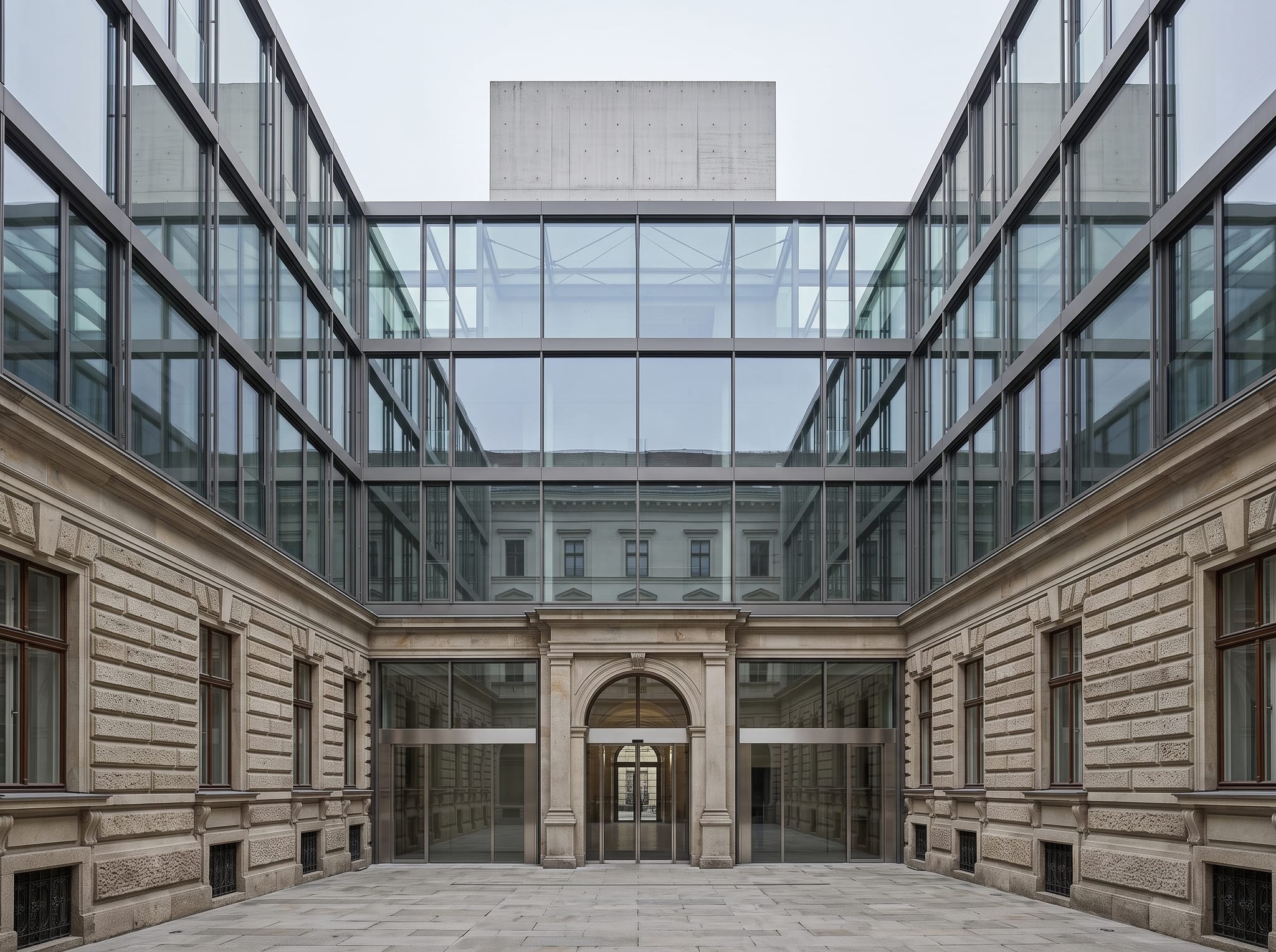 The inner courtyard of Palais Auersperg, where the new glazed structure meets the retained historic walls