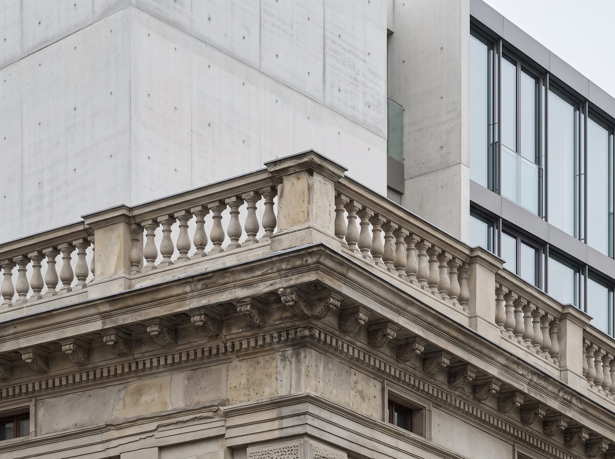 Detail of Palais Auersperg where the retained stone cornice meets the new concrete storey above it