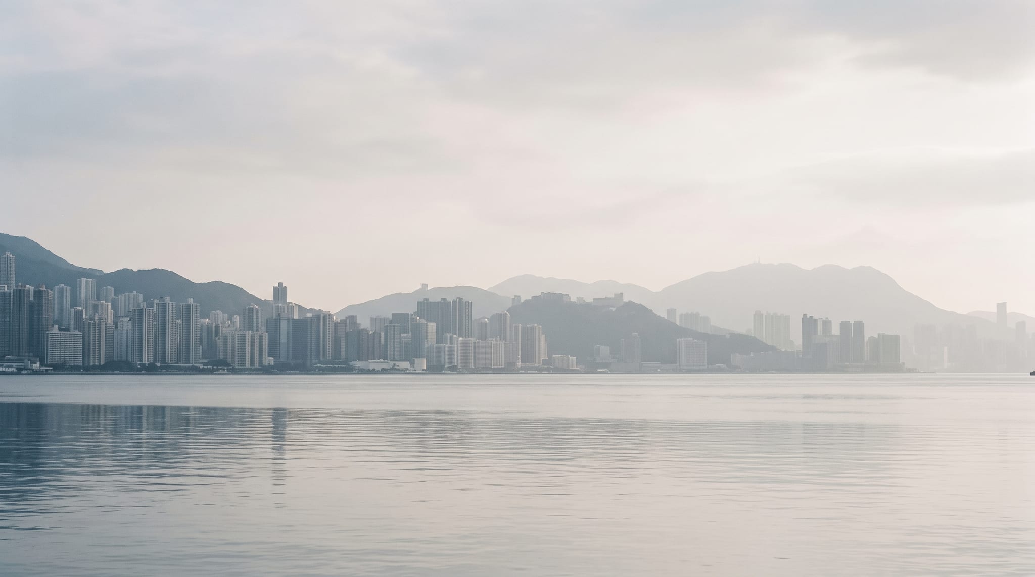 Hong Kong harbour with headlands receding into pale atmospheric layers