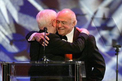 Director-Member Daniel Petrie, Sr. greets his old Northwestern University classmate Larry Auerbach with a hearty embrace.