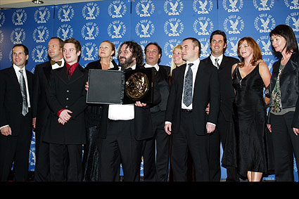 Jackson displays his award with members of his team. From left: Executive producer Mark Ordesky, key 2nd AD Marc Ashton, Elijah Wood, 1st AD Carolynne Cunningham, UPM Zane Weiner, Niki Harris, UPM Nikolas Korda, key 2nd AD Guy Campbell, 2nd 2nd AD Joanne Pearce and costume designer Ngila Dickson.