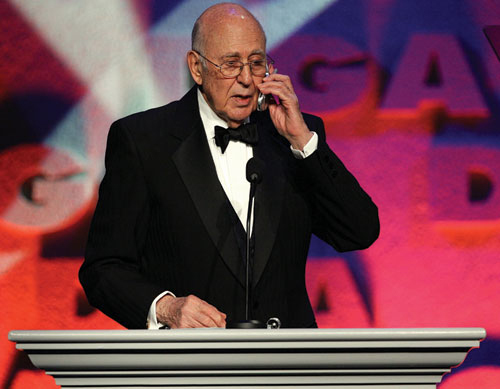 Host Carl Reiner has a little cell phone fun.