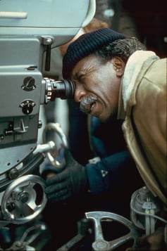 ARTIST AT WORK: Parks in a familiar position, looking at the world through a lens on the set of Shaft's Big Score! - photo courtesy Hulton Archive/Getty Images 