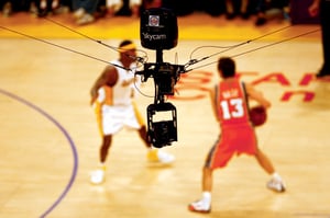  THE COACH: Director Jimmy Moore in the control room with more than 100 screens blinking. -Photo by Wendi Kaminski