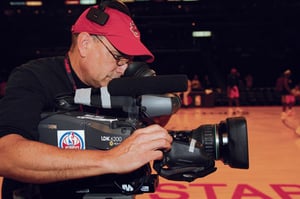 WHAT'S THE PLAY?: The director guides the camera into the huddle during a timeout to get the inside scoop.