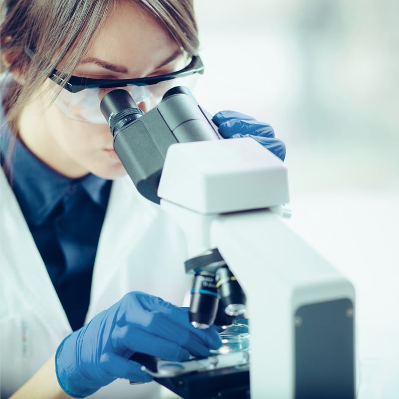 Scientists with microscope to illustrate life sciences transactions