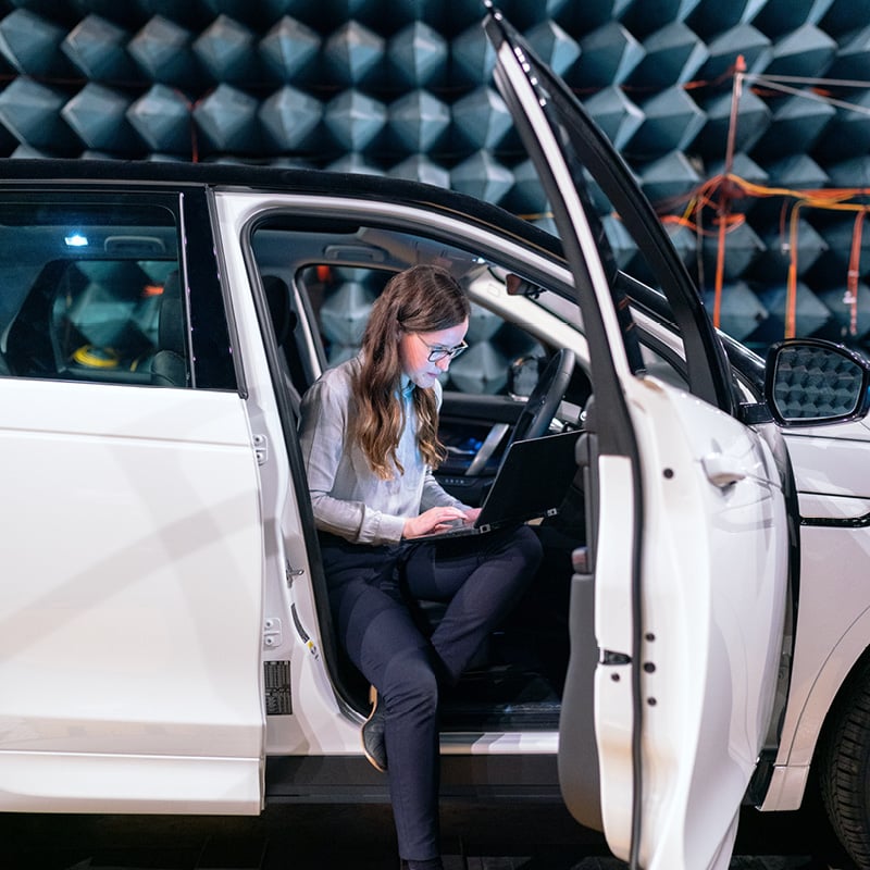 Woman getting out of car to illustrate automotive