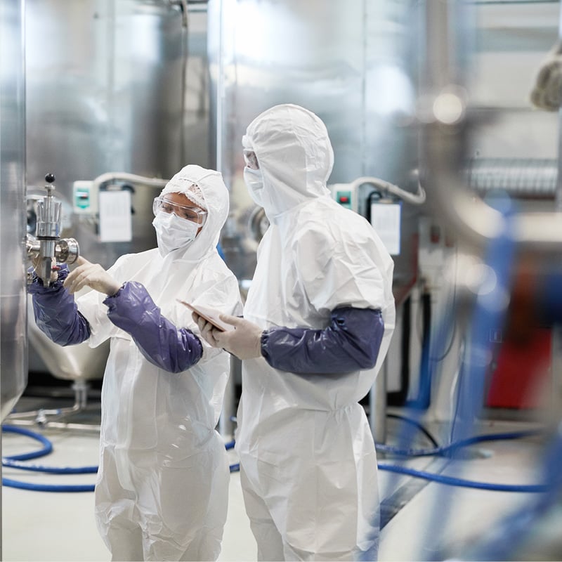 Scientists in lab gear to illustrate chemicals