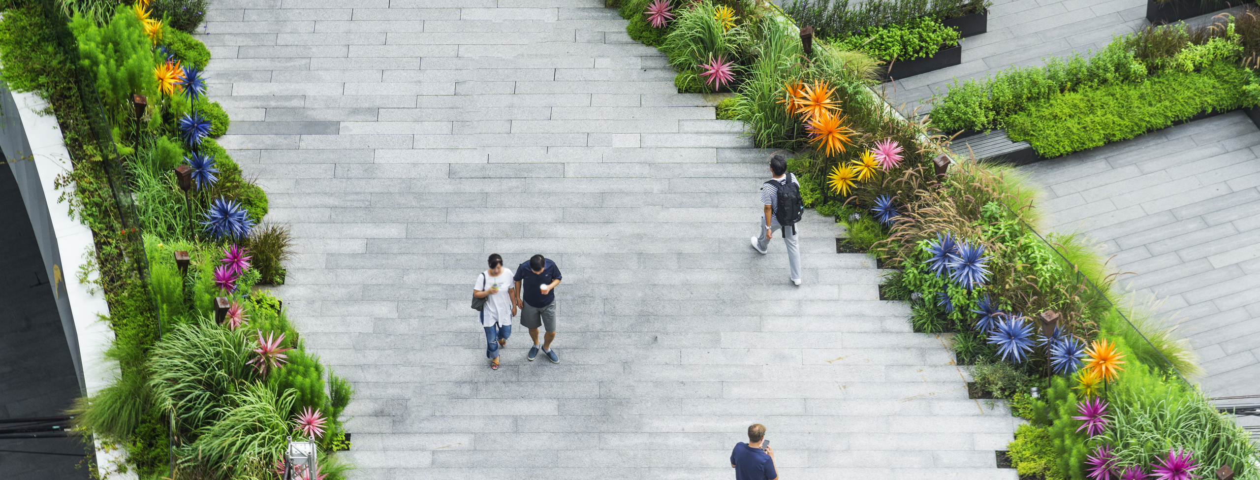 Areial view of people walking on city green area