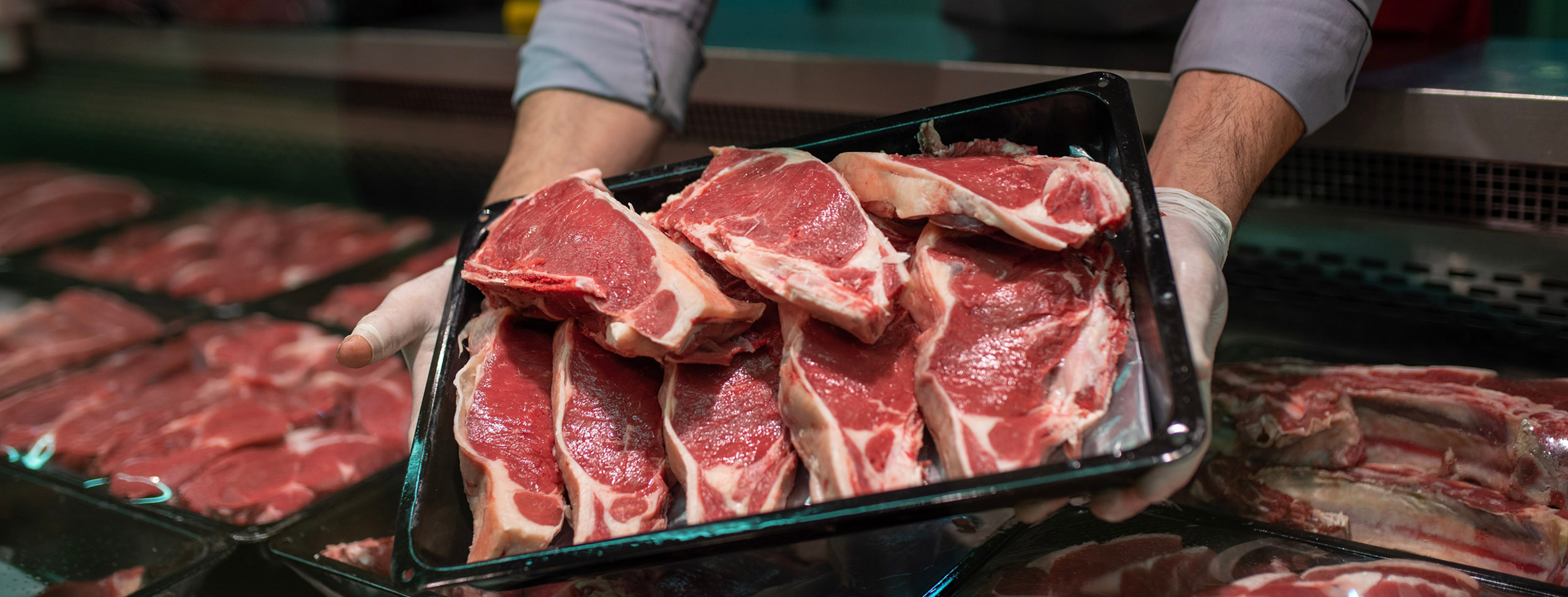 Butcher_holding_meat 2560x975
