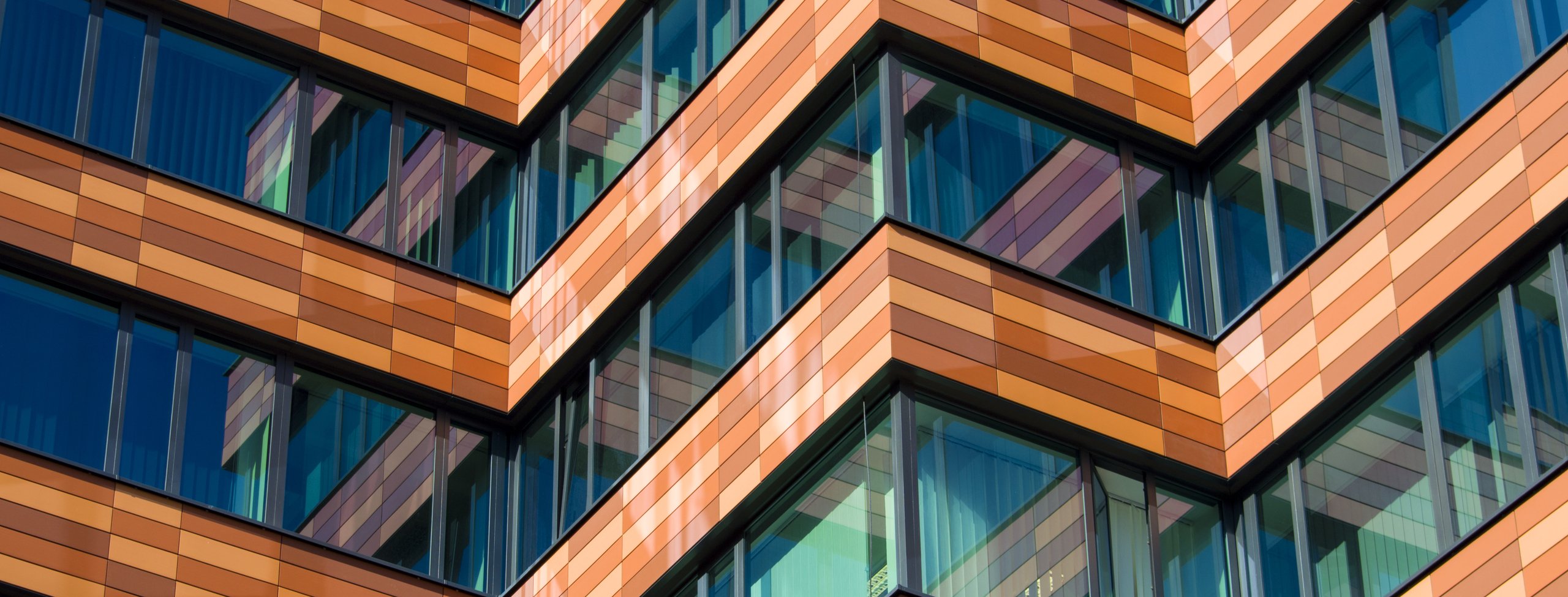zigzag building with lines of windows and brown sections