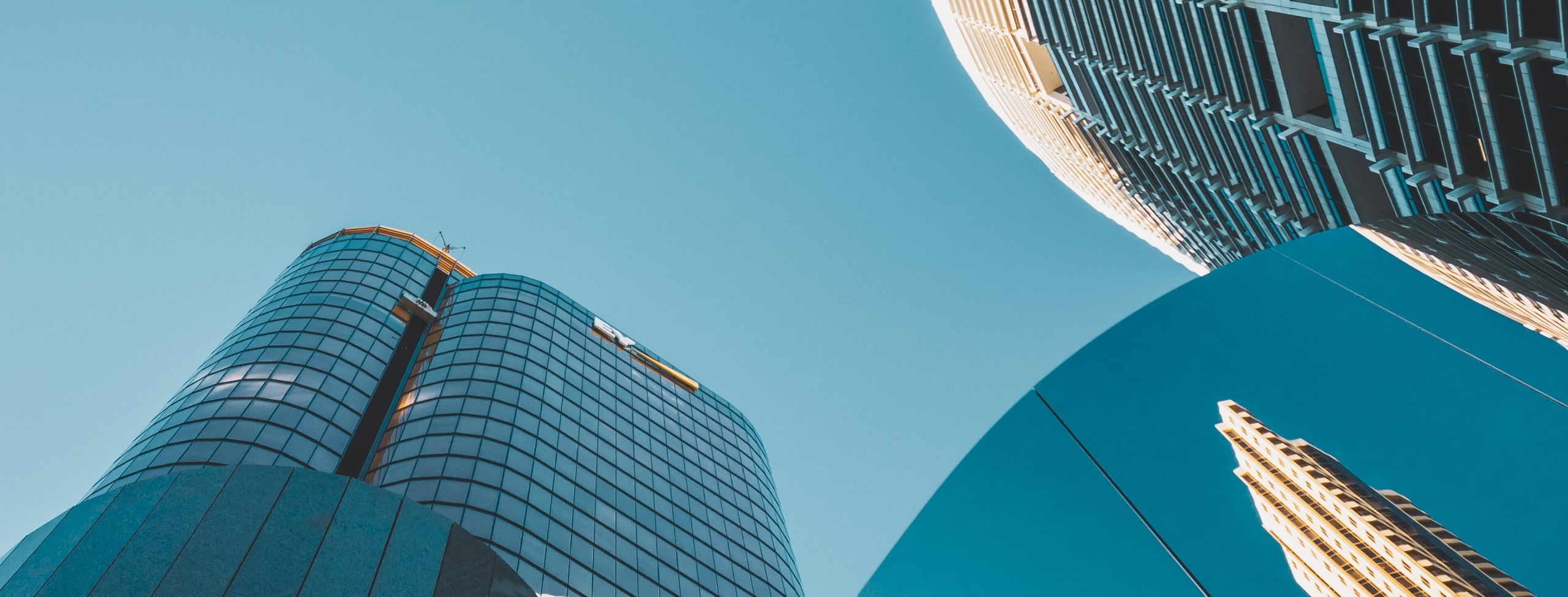 Low angle photo of mirror high rise buildings-