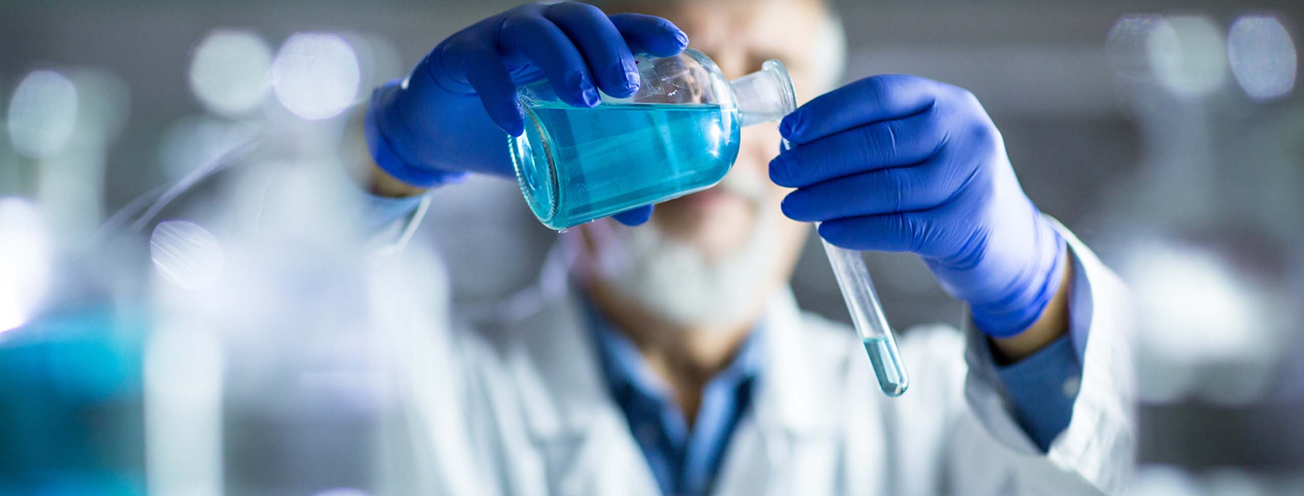 close up of male-scientist-in-laboratory-with-test-tube