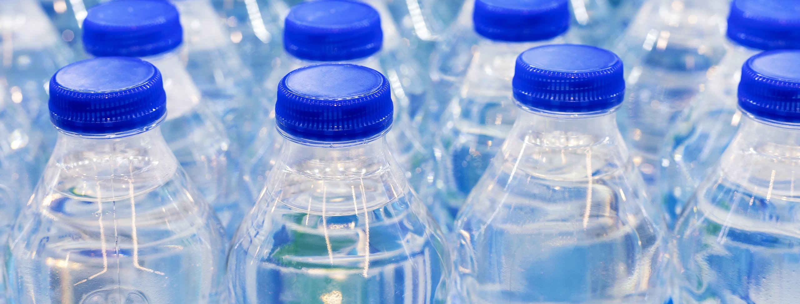 many plastic water bottles in a line