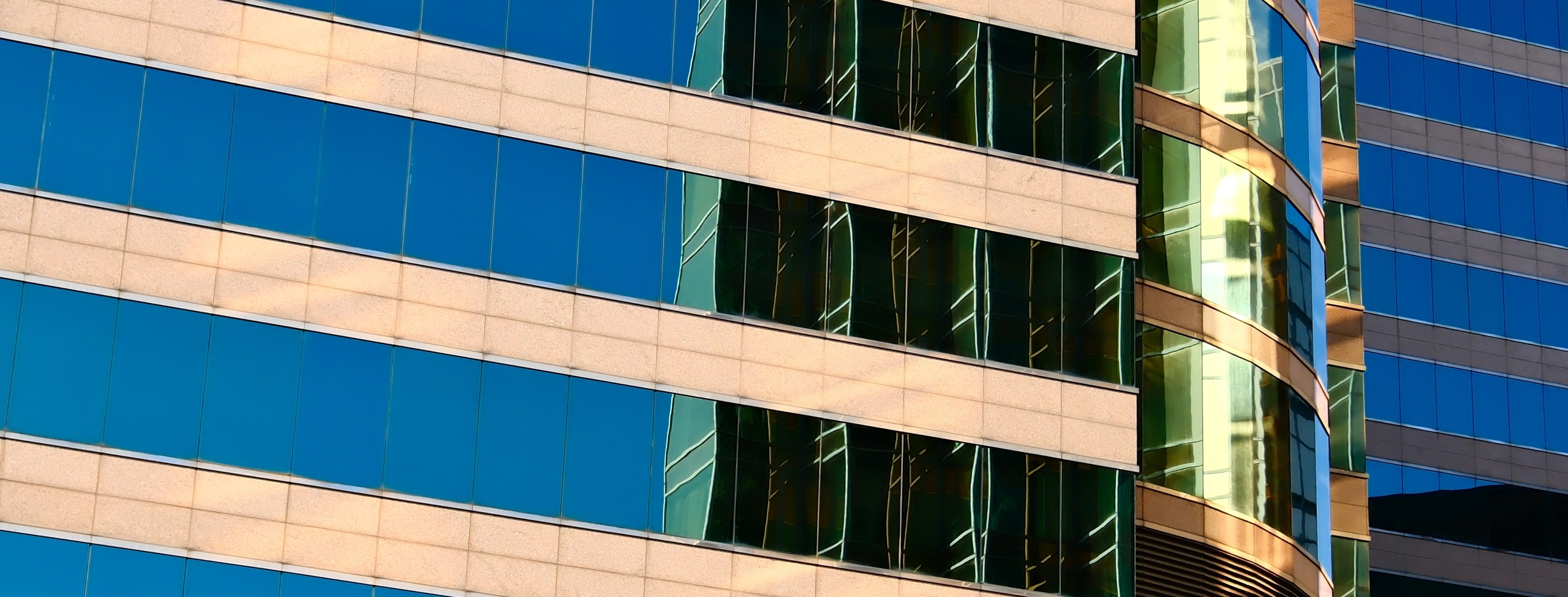 Modern_office_building_facade_with_striped_horizontal_panels_and_windows