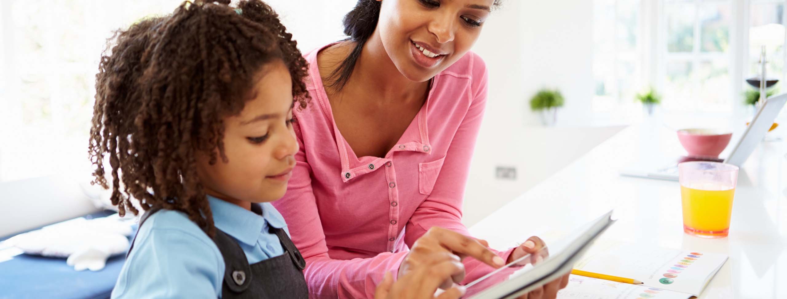 Mother and child doing homework on a tablet