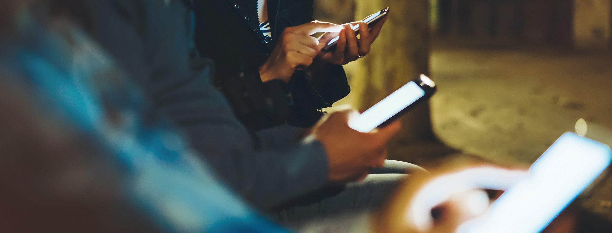 cropped image of people using phones