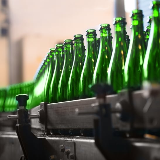 Green glass bottles in factory
