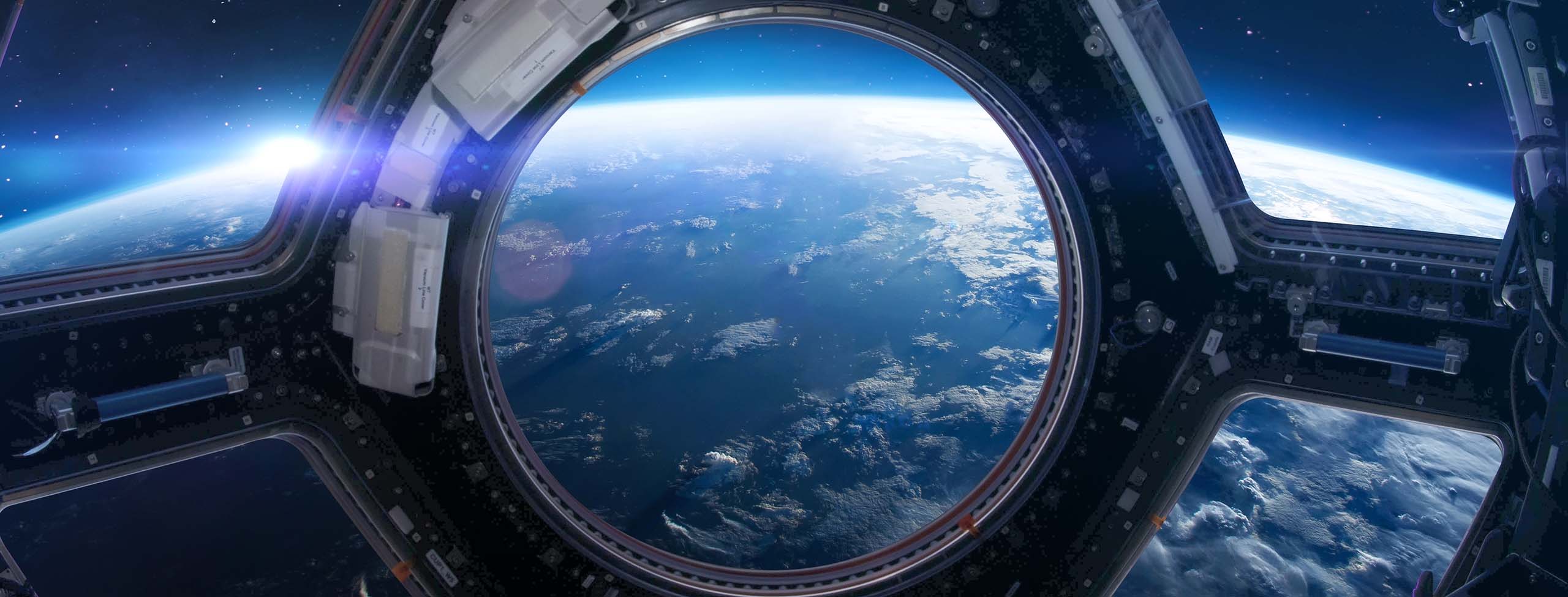 Cupola porthole on space station 2560x975